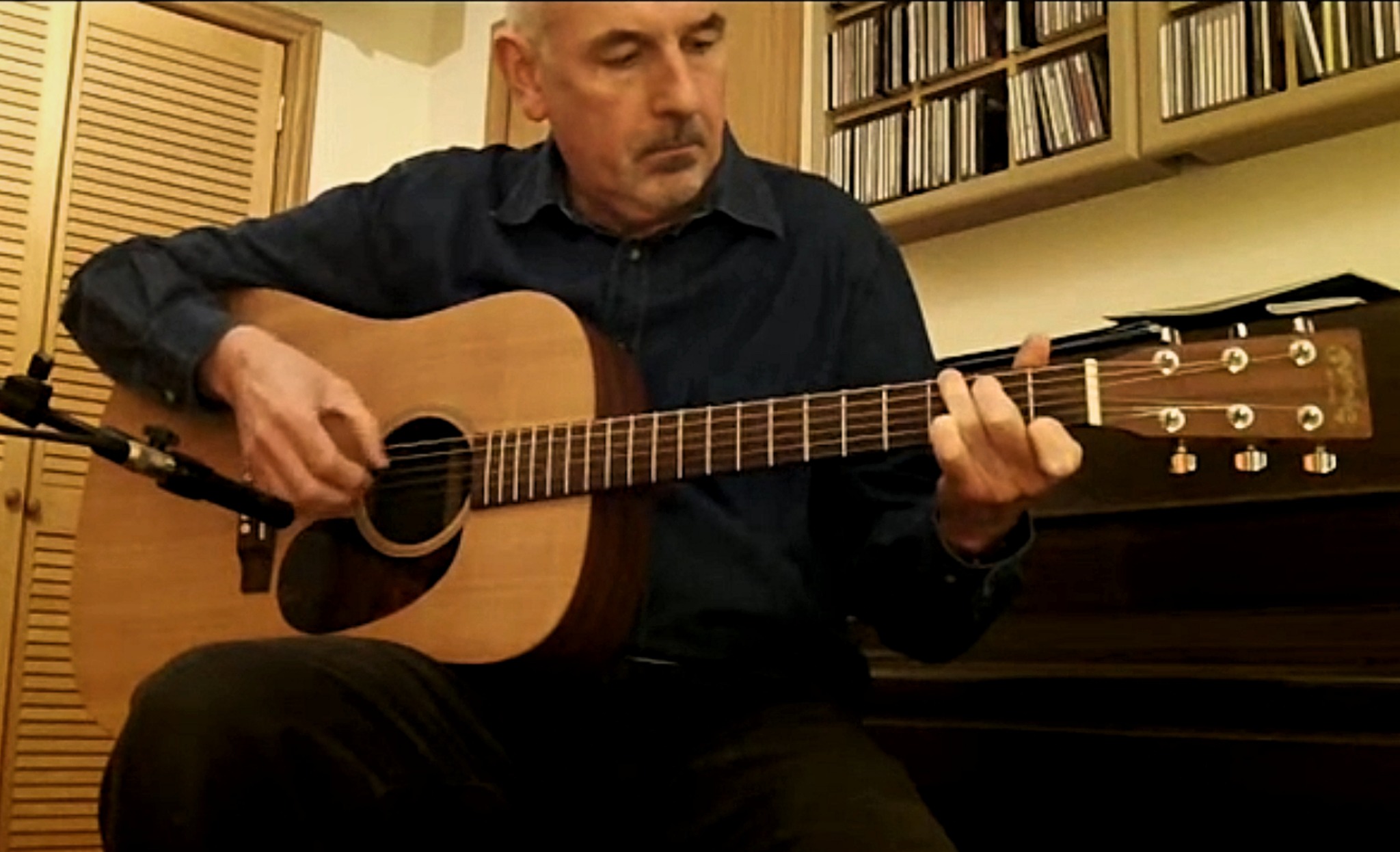 Ray Norris playing acoustic guitar